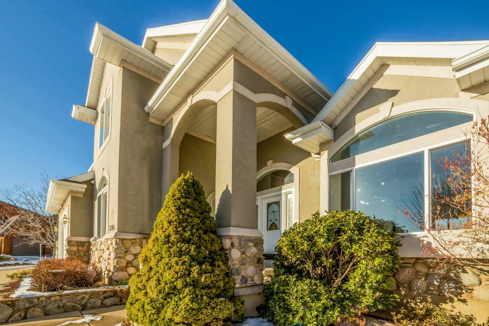 Morrison Ranch–style farm-village home in Gilbert with premium stucco, tile roof, and mature landscaping — the neighborhood aesthetic that rewards recurring pooper scooper service
